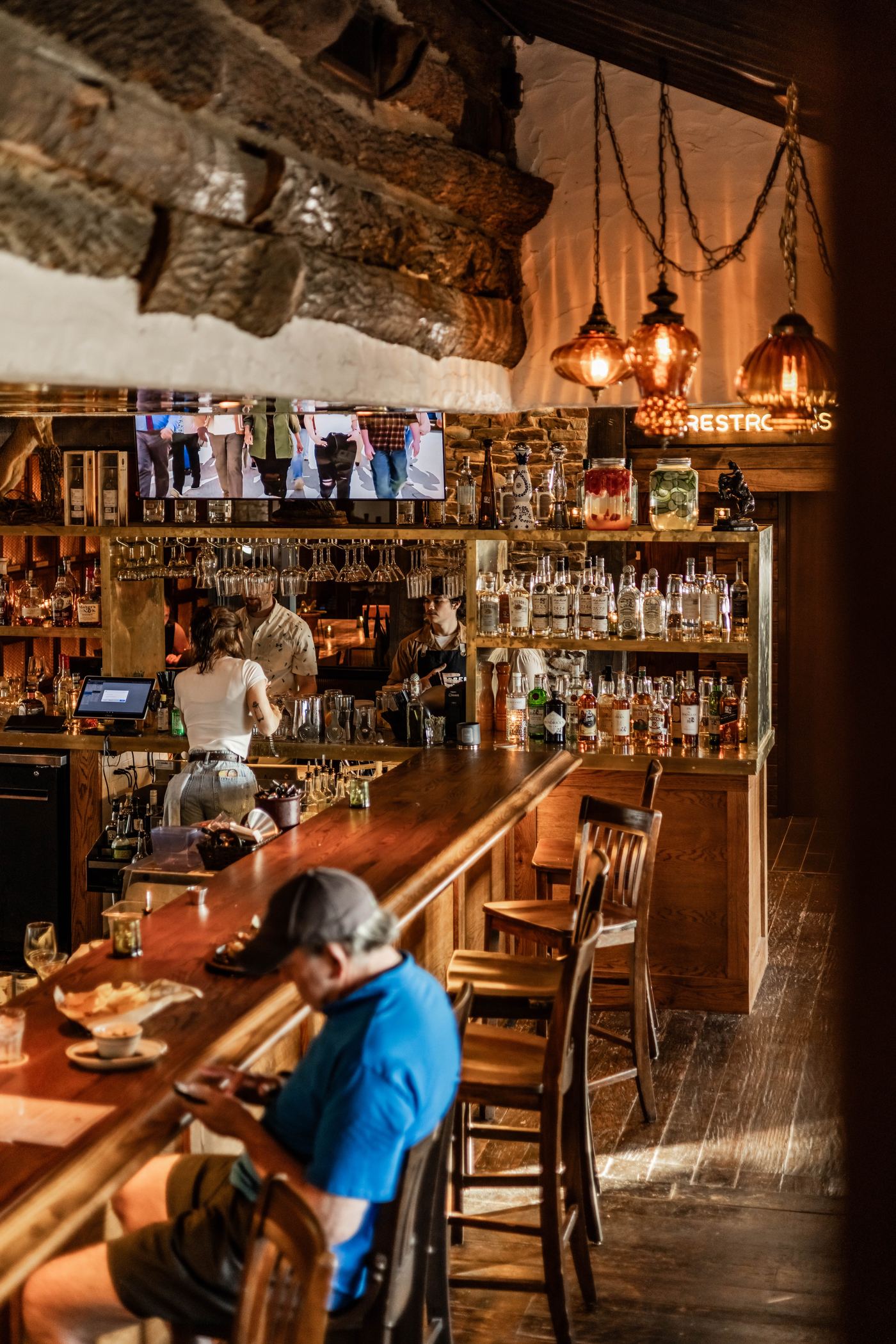New bar at Culpepper Cattle Co. Rockwall beneath the building's original timber beams and stone