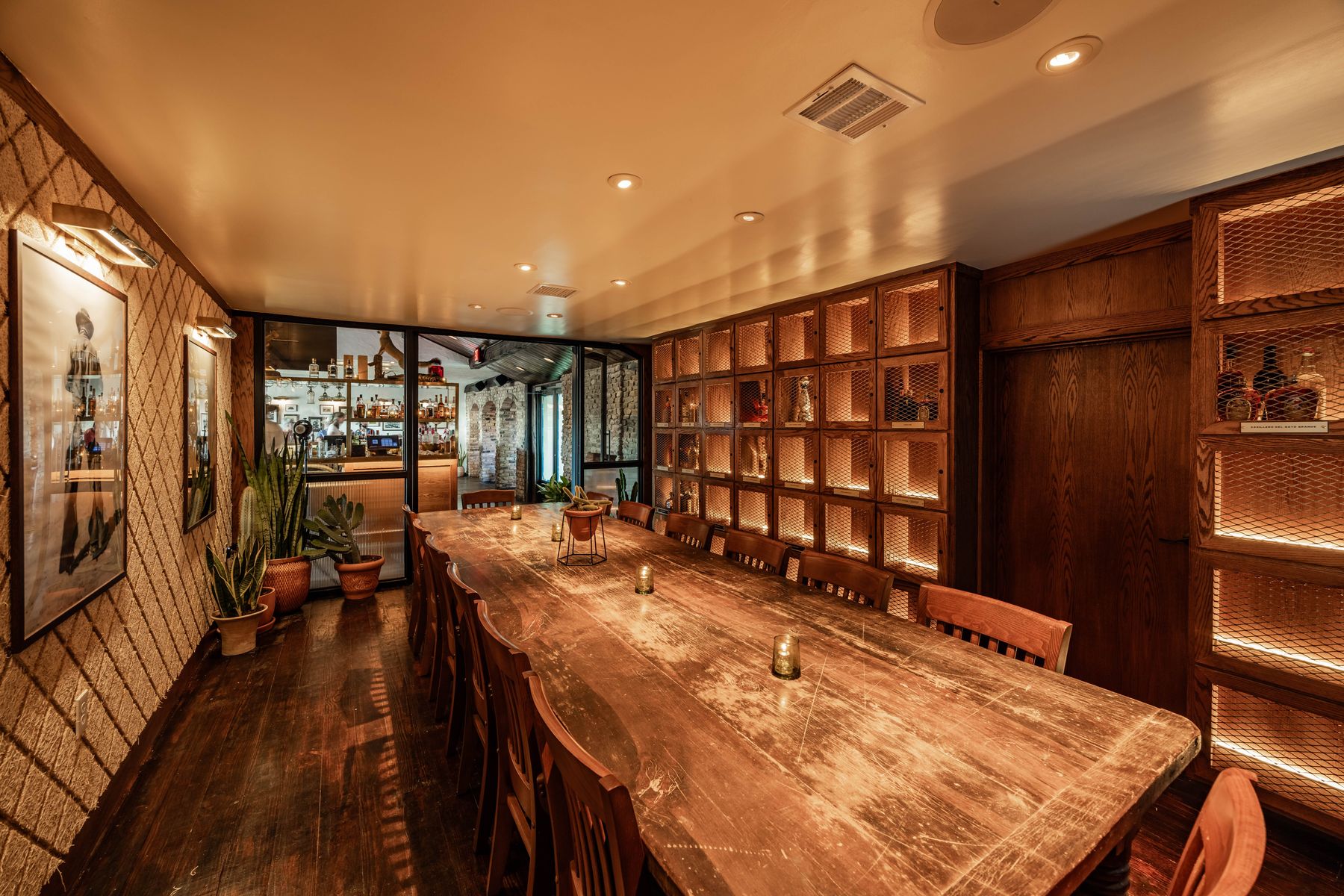 Founders Room at Culpepper Cattle Co. Rockwall — long communal table with backlit oak spirit lockers
