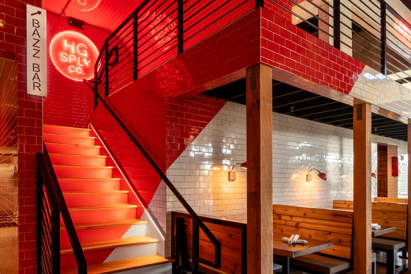 Red and white tiled staircase at HG Sply Co. Alliance with neon signage